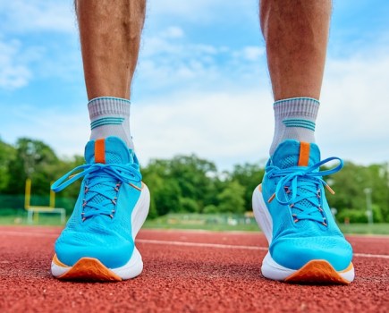 Close-up of a male runner's feet on a running track