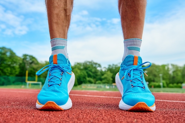 Close-up of a male runner's feet on a running track