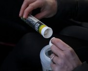 Electrolyte tab being put in a water bottle