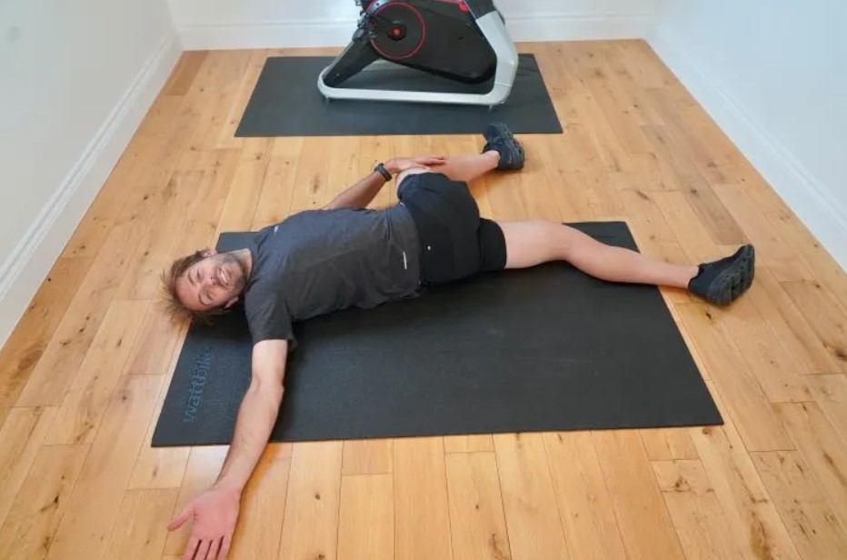 Man performing a spine twist on an exercise mat