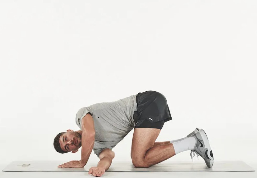 Man performing a thread the needle yoga pose