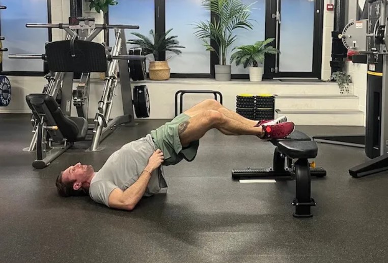 Man performing a 'frogger' floor exercise