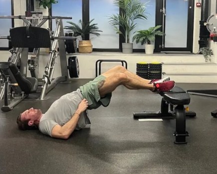 Man performing a 'frogger' floor exercise