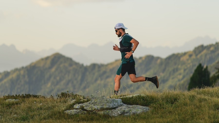 Young sportsman during a long distance trail run in the mountains