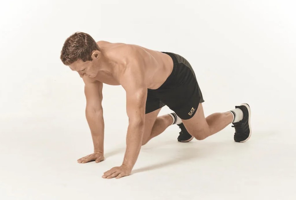 Man performing a bear crawl exercise