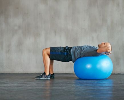 A man lying on an exercise ball