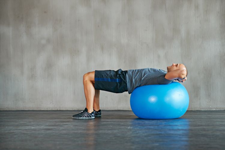 A man lying on an exercise ball