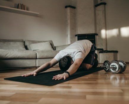 close-up of a man doing yoga on an exercise mat