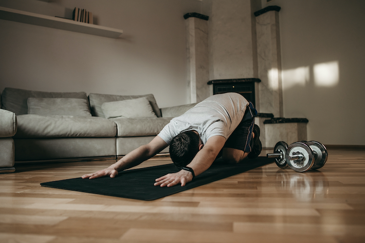 close-up of a man doing yoga on an exercise mat