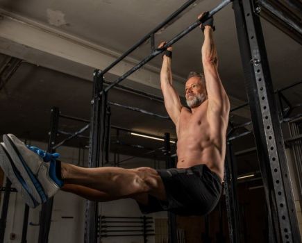 Man using a pull-up bar wearing gym shorts