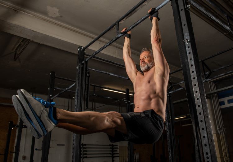 Man using a pull-up bar wearing gym shorts