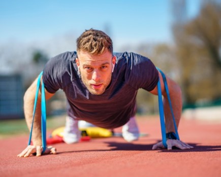 Man doing push-ups with a resistance band