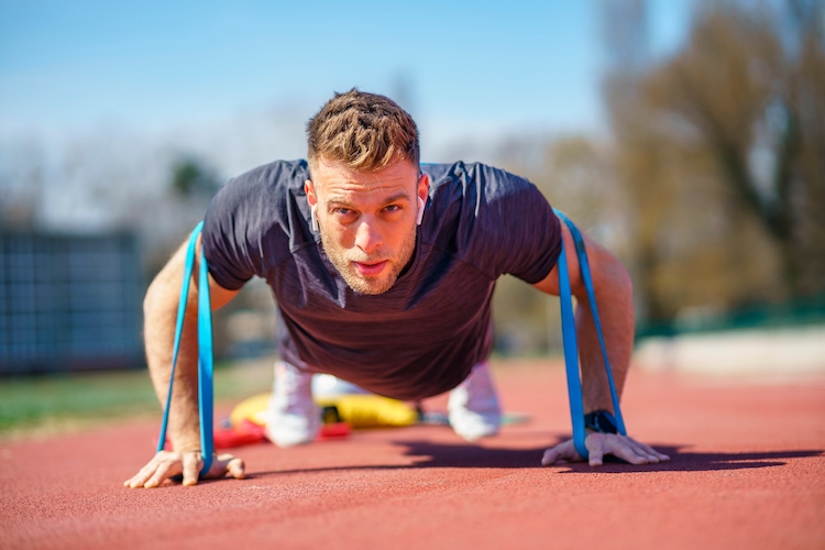 Man doing push-ups with a resistance band