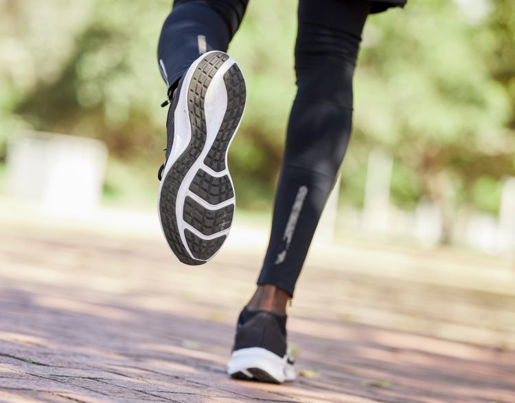 Close up of a man's lower legs and running shoes