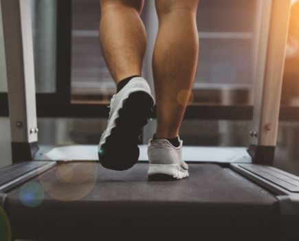 Close-up of a man's feet on a treadmill