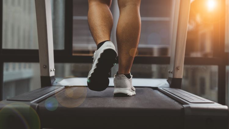 Close-up of a man's feet on a treadmill