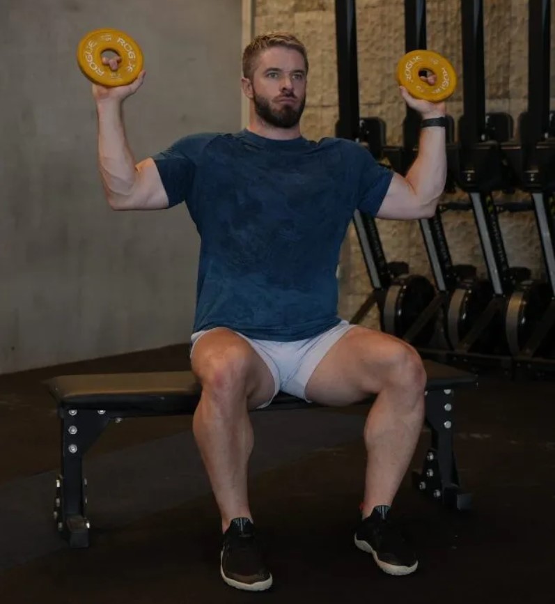 Man performing a Cuban press