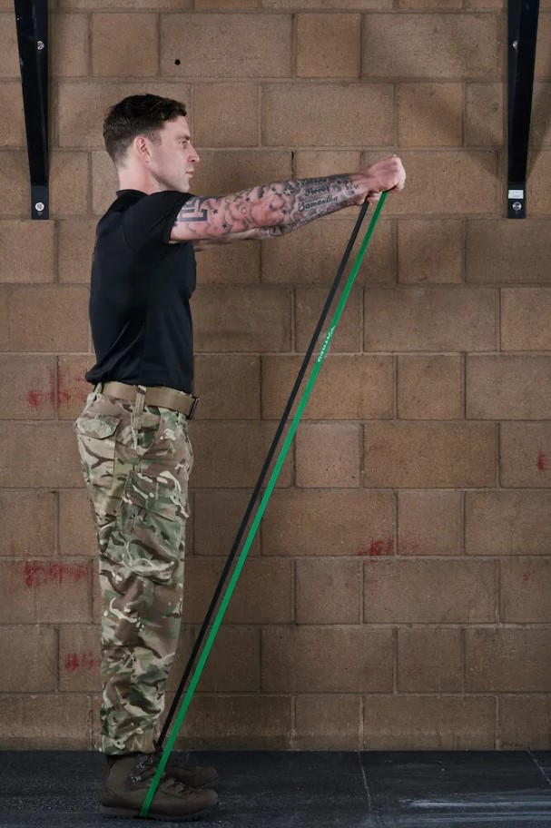 Man performing a banded front raise