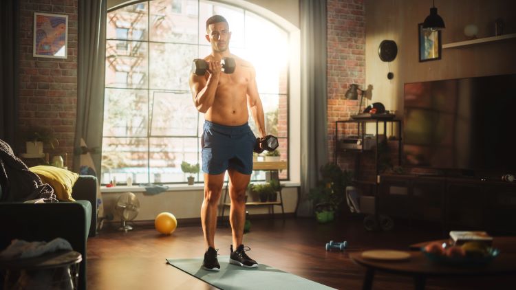 Man using gym equipment at home