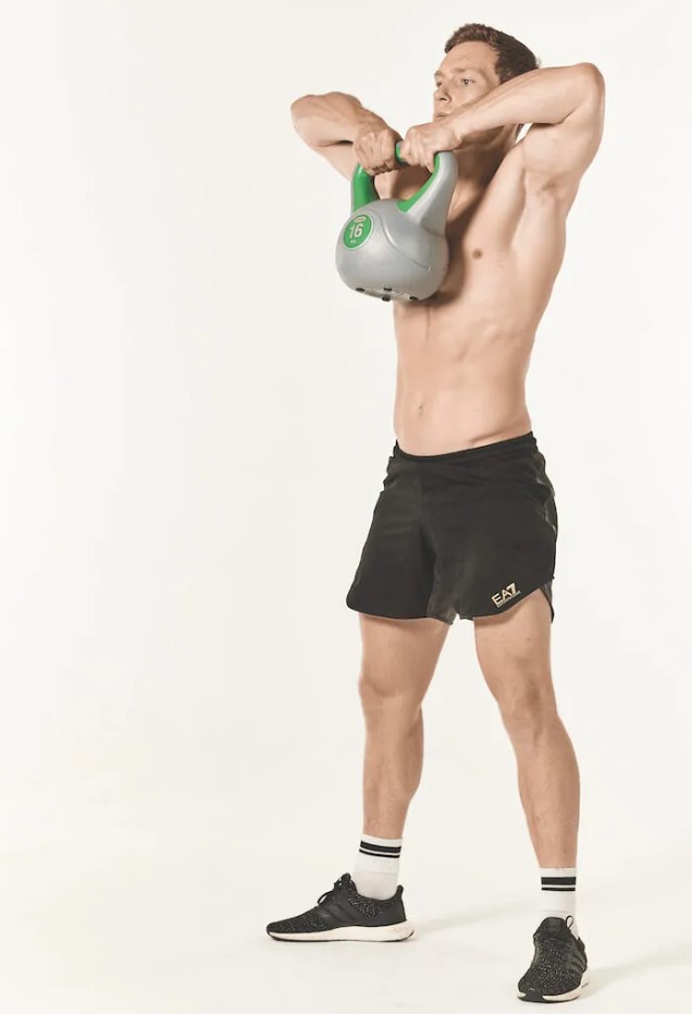 Man performing a kettlebell upright row