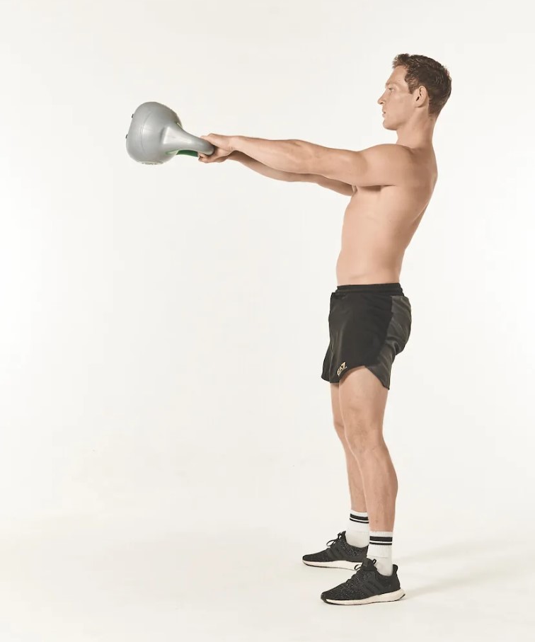 Man performing a kettlebell swing