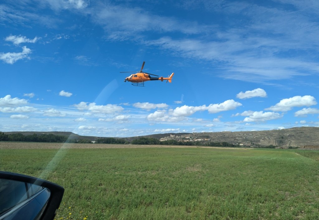 A TV helicopter hovering by the side of the race