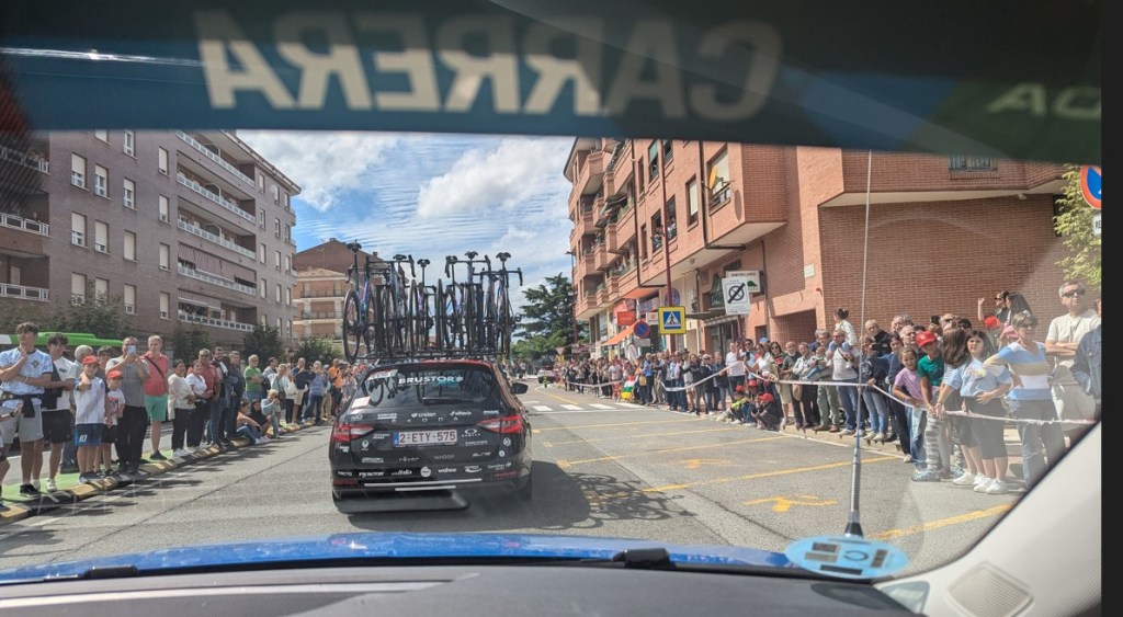 In the race convoy with crowds lining the pavements