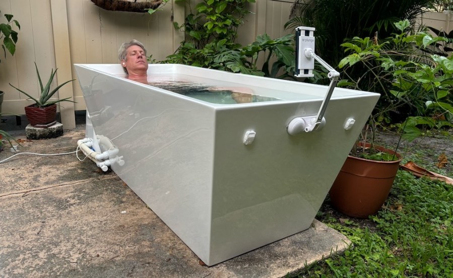 A man lying in an outdoor ice bath