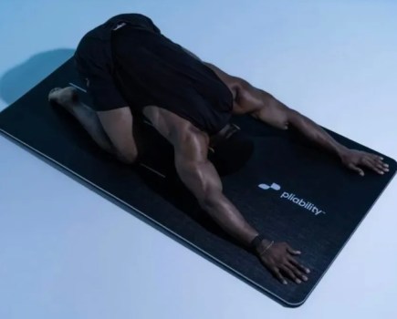 A man stretching on a yoga mat