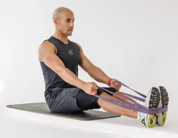 Man performing a banded seated back row