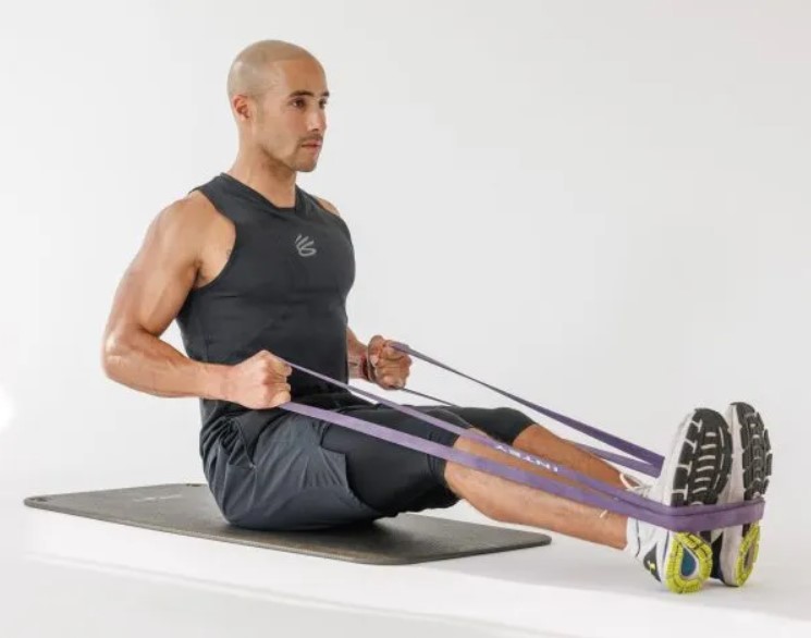 Man performing a banded seated back row