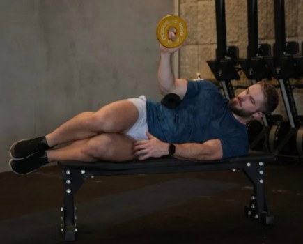 Man lying on his side performing rotator cuff exercises