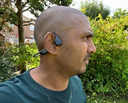 Close-up of a runner wearing open-ear headphones