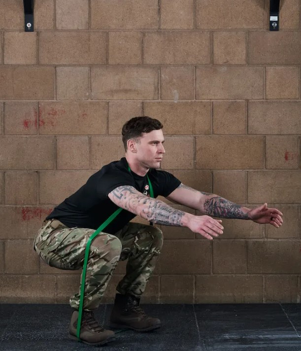 Man performing a banded squat