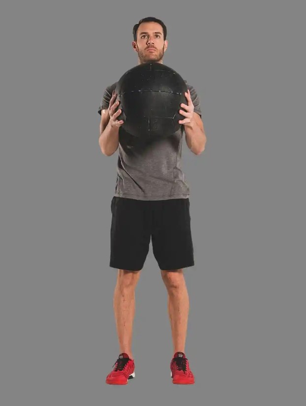 Man performing a medicine ball lunge and twist