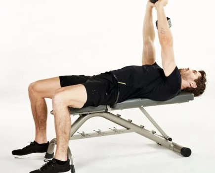 Man on a weight bench performing a dumbbell pullover