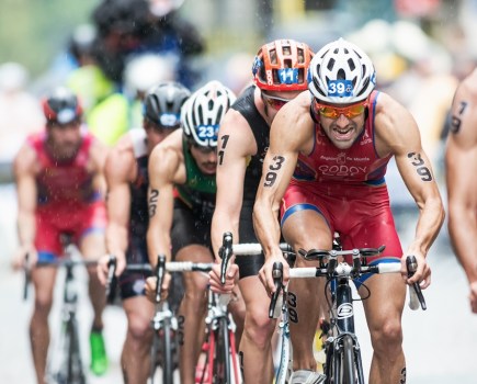 STOCKHOLM - AUG, 23: Cyclist with Francesco Godoy leading a group on the wet cobblestone road at the Mens ITU World Triathlon Series event August 23, 2014 in Stockholm, Sweden