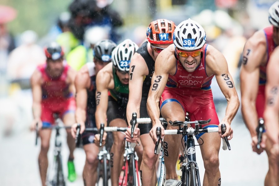 STOCKHOLM - AUG, 23: Cyclist with Francesco Godoy leading a group on the wet cobblestone road at the Mens ITU World Triathlon Series event August 23, 2014 in Stockholm, Sweden