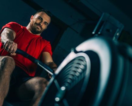 Close-up of a man using a rowing machine