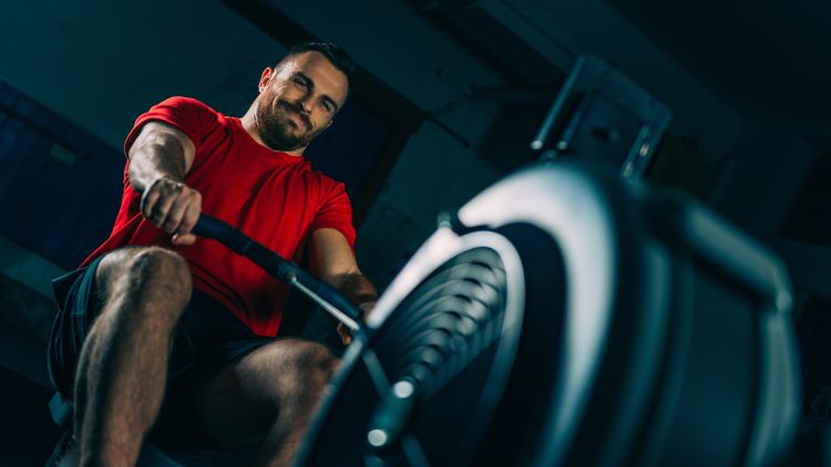 Close-up of a man using a rowing machine