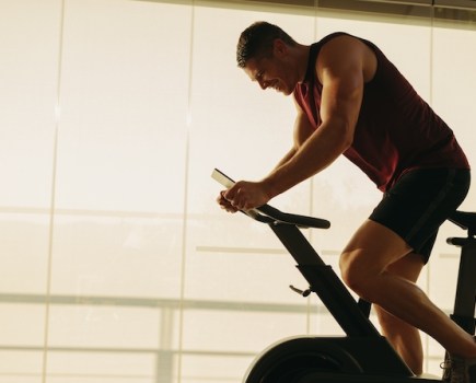 Man pedalling on an indoor exercise bike