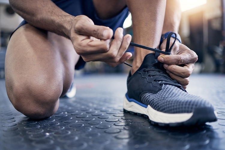 Close-up of a man tying his gym shoes