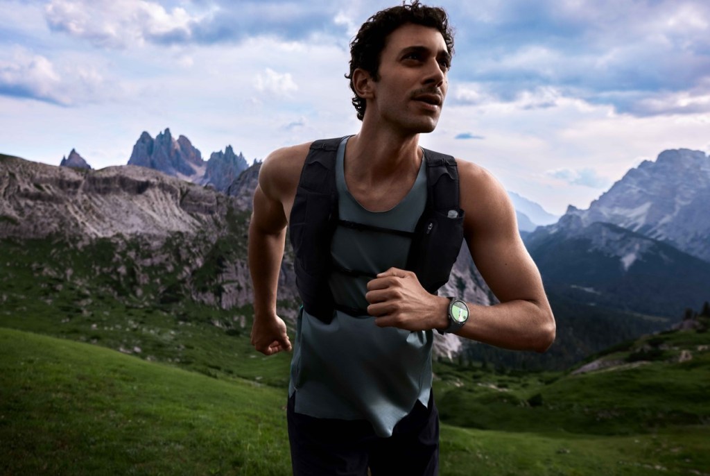 A man running off-road with mountains in the background