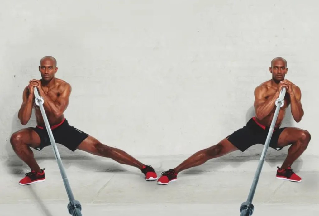 Man performing a landmine lateral lunge