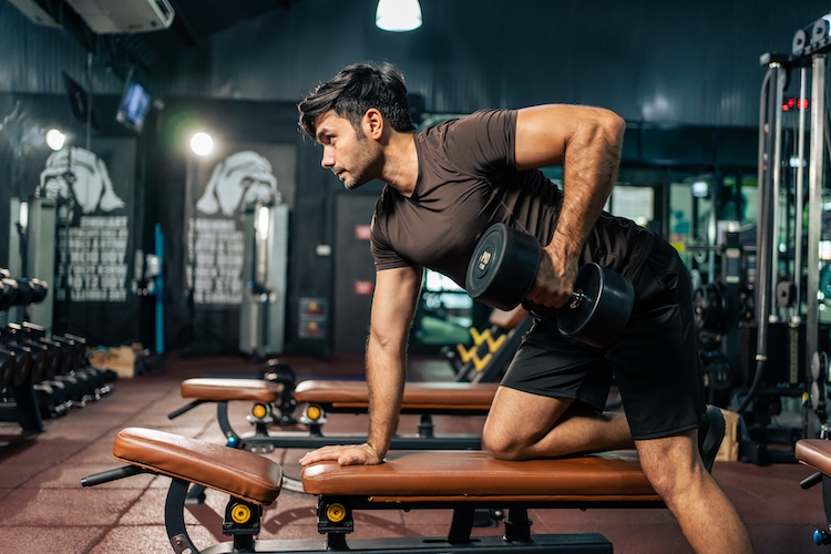 Man working out with dumbbells in a gym