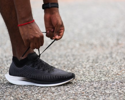 Close-up of hands tying gym shoe laces