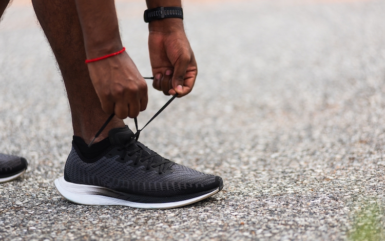 Close-up of hands tying gym shoe laces