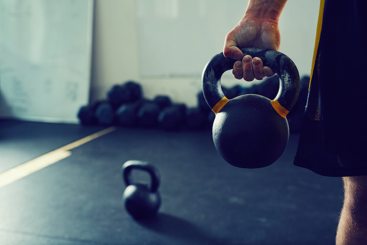 Close-up of a man's hand holding a kettlebell