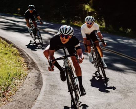 Three cyclists wearing cycling glasses in sunshine