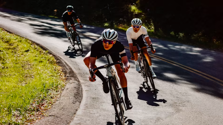 Three cyclists wearing cycling glasses in sunshine